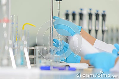 The woman whoâ€™s the scientist is demonstrate the titration technique Stock Photo